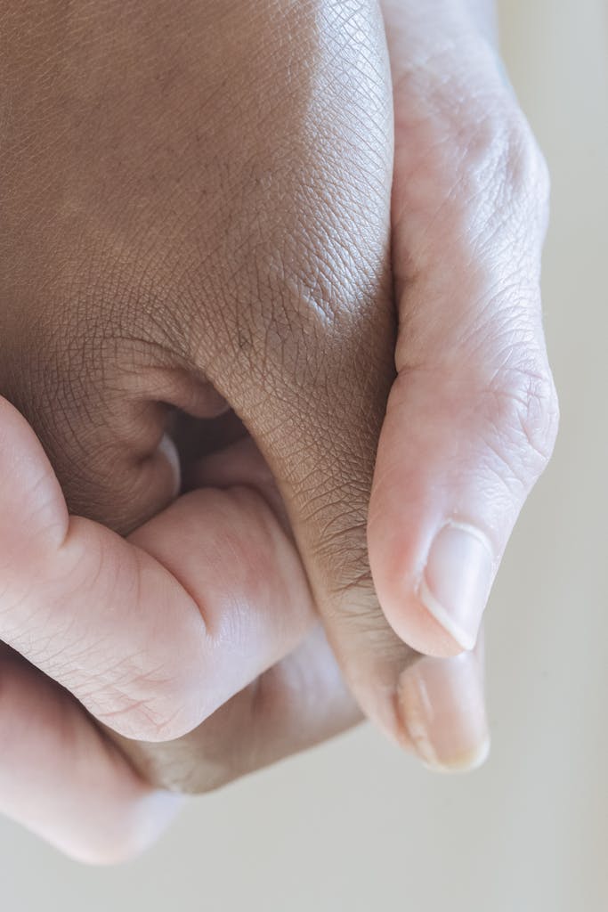 Diverse females holding hands gently for unity